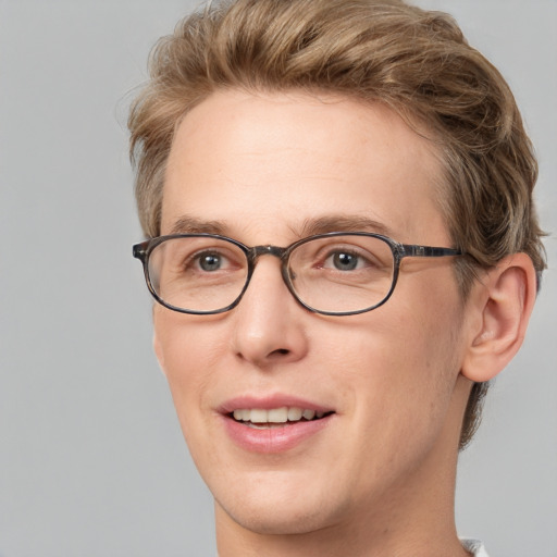 Joyful white adult male with short  brown hair and blue eyes