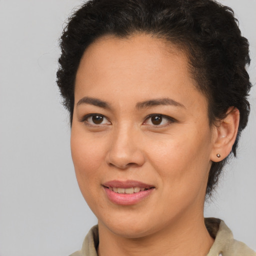 Joyful latino young-adult female with short  brown hair and brown eyes