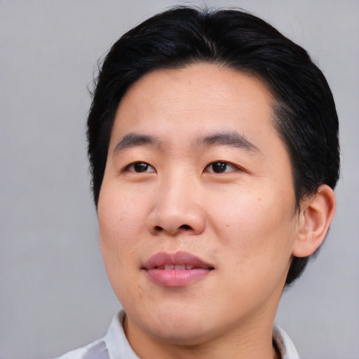 Joyful asian young-adult male with short  black hair and brown eyes