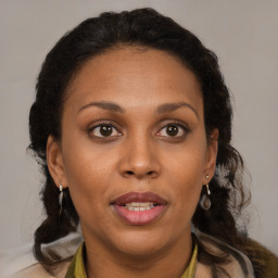 Joyful black adult female with medium  brown hair and brown eyes
