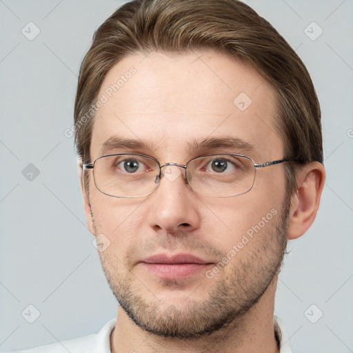 Joyful white adult male with short  brown hair and grey eyes