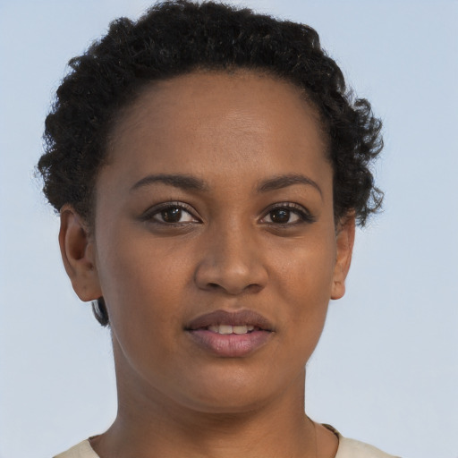 Joyful black young-adult female with short  brown hair and brown eyes