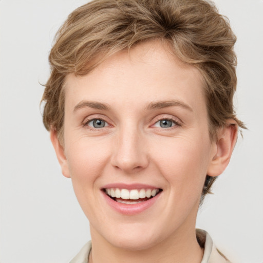 Joyful white young-adult female with short  brown hair and grey eyes