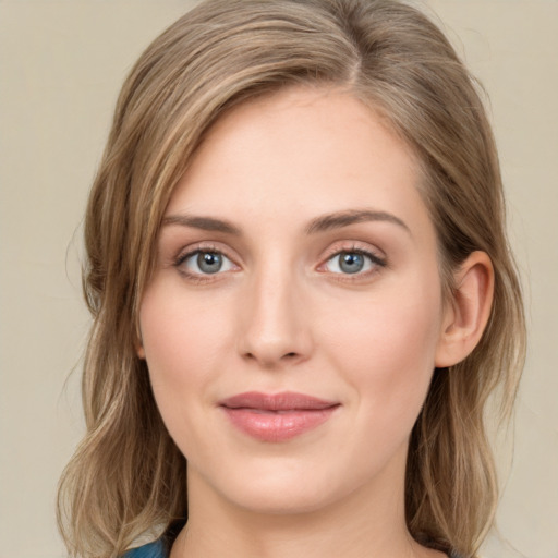 Joyful white young-adult female with medium  brown hair and green eyes