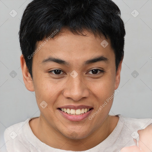 Joyful asian young-adult male with short  brown hair and brown eyes