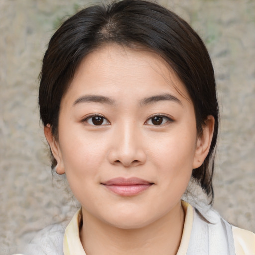 Joyful asian young-adult female with medium  brown hair and brown eyes