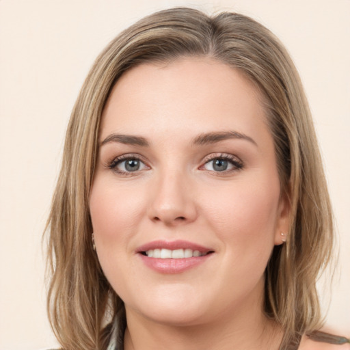 Joyful white young-adult female with long  brown hair and green eyes