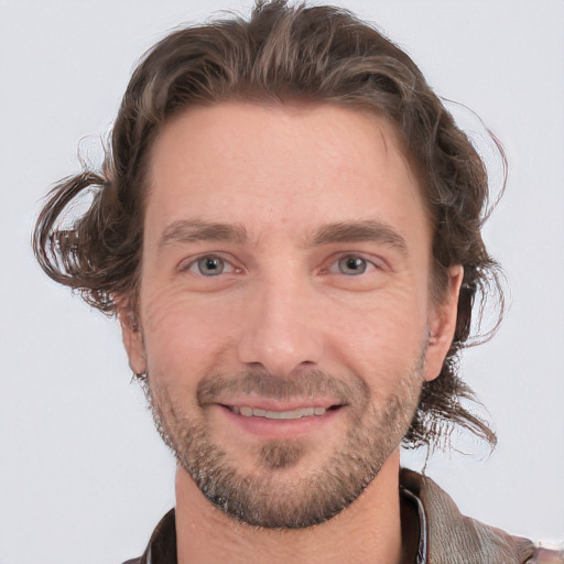 Joyful white adult male with short  brown hair and grey eyes