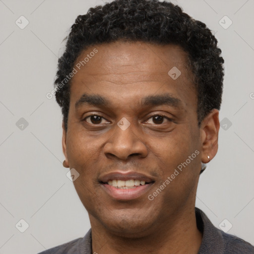 Joyful black young-adult male with short  black hair and brown eyes