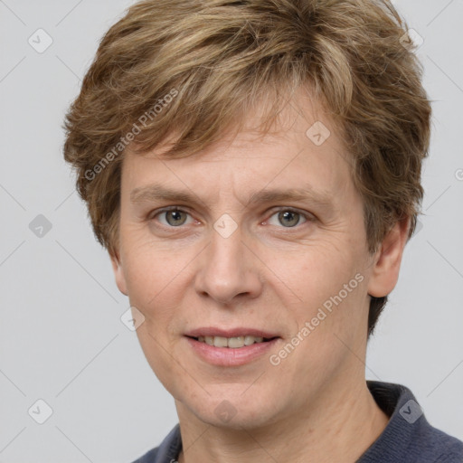 Joyful white adult male with short  brown hair and grey eyes