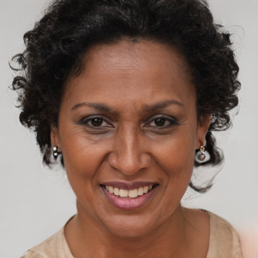 Joyful black adult female with short  brown hair and brown eyes