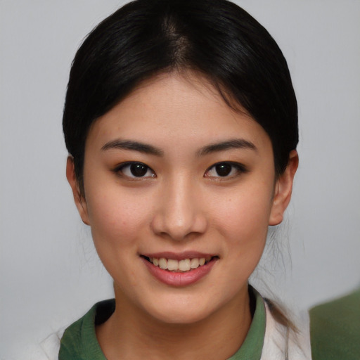 Joyful asian young-adult female with short  brown hair and brown eyes