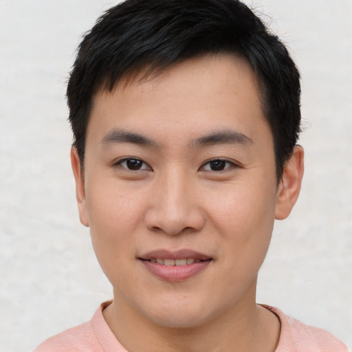 Joyful asian young-adult male with short  brown hair and brown eyes