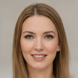 Joyful white young-adult female with long  brown hair and green eyes