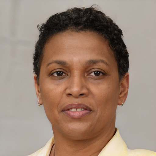 Joyful black adult female with short  brown hair and brown eyes