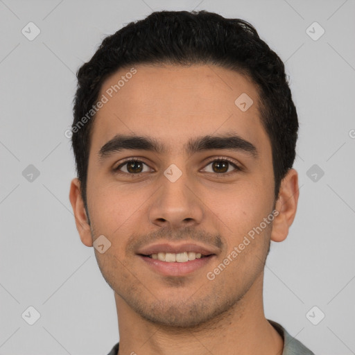 Joyful white young-adult male with short  black hair and brown eyes