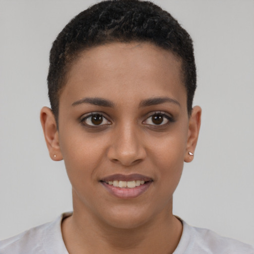 Joyful black young-adult female with short  brown hair and brown eyes