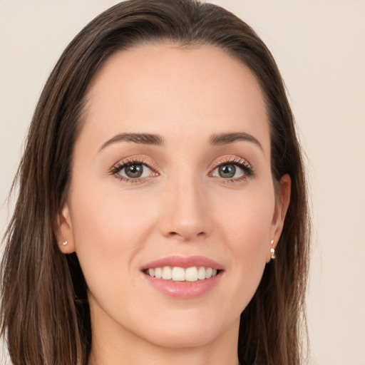 Joyful white young-adult female with long  brown hair and brown eyes