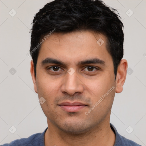 Joyful white young-adult male with short  black hair and brown eyes