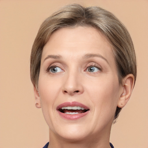 Joyful white adult female with medium  brown hair and grey eyes