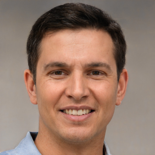 Joyful white adult male with short  brown hair and brown eyes