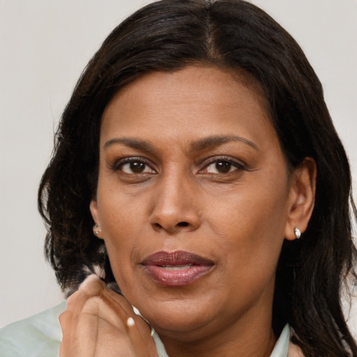 Joyful black adult female with medium  brown hair and brown eyes