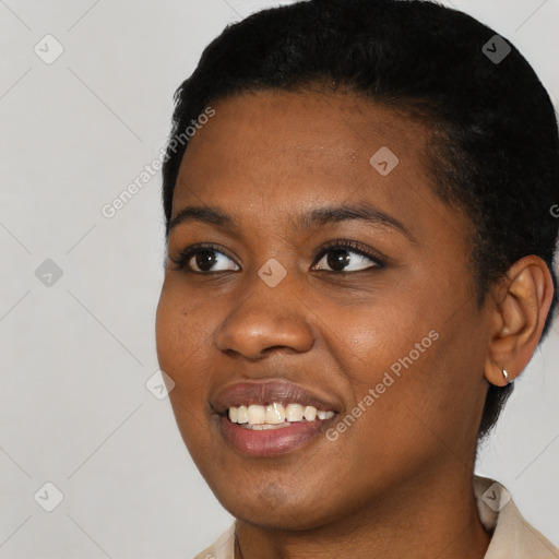 Joyful black young-adult female with short  black hair and brown eyes