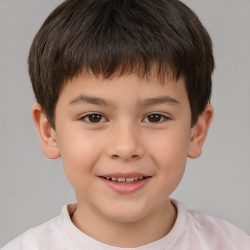 Joyful white child male with short  brown hair and brown eyes