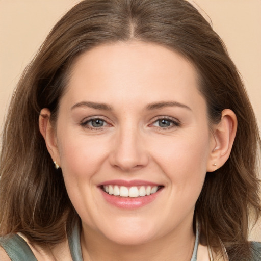 Joyful white young-adult female with long  brown hair and grey eyes