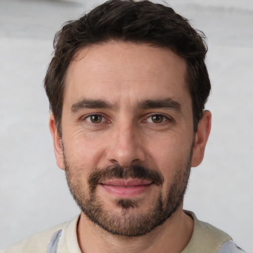 Joyful white young-adult male with short  black hair and brown eyes