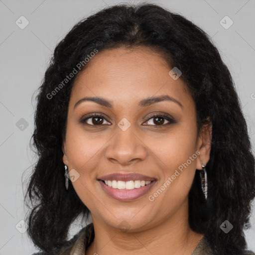 Joyful black young-adult female with long  brown hair and brown eyes