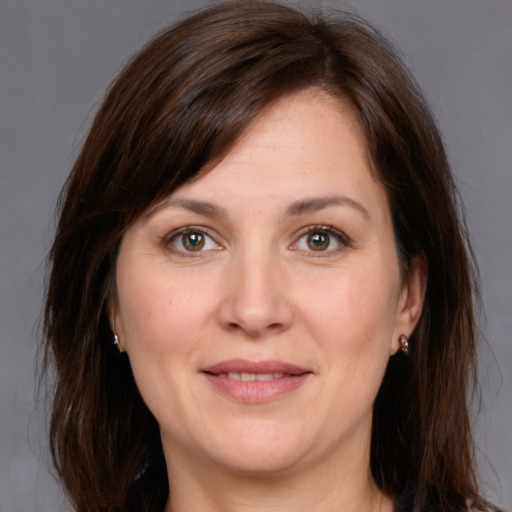 Joyful white adult female with medium  brown hair and brown eyes