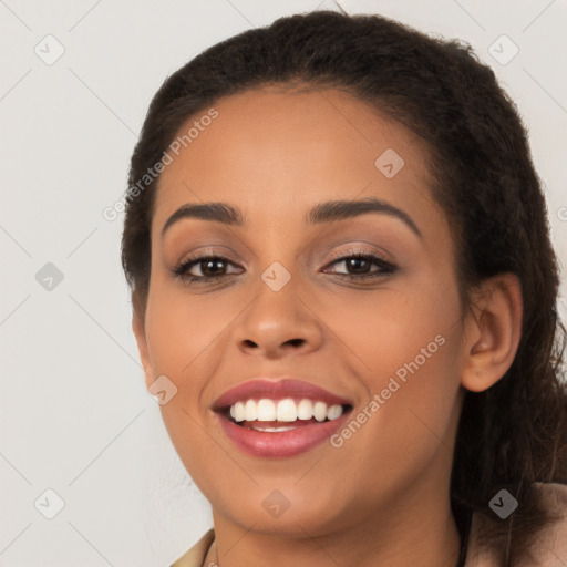 Joyful latino young-adult female with long  brown hair and brown eyes