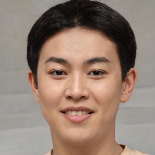 Joyful asian young-adult male with short  brown hair and brown eyes