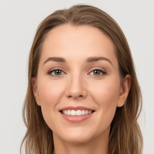 Joyful white young-adult female with long  brown hair and grey eyes