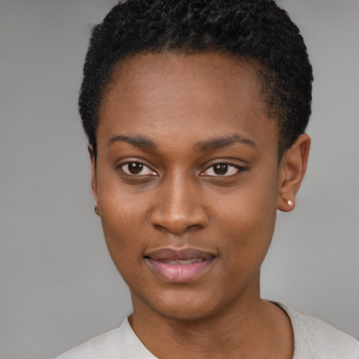 Joyful black young-adult female with short  black hair and brown eyes
