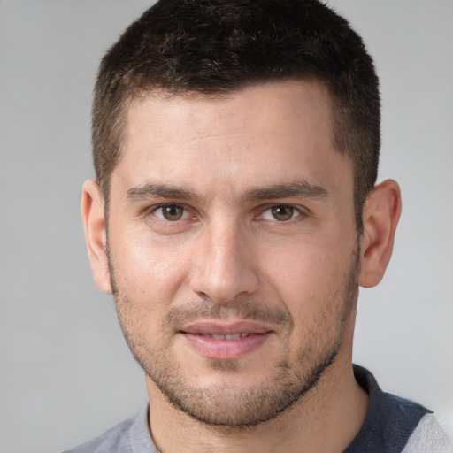 Joyful white young-adult male with short  brown hair and brown eyes