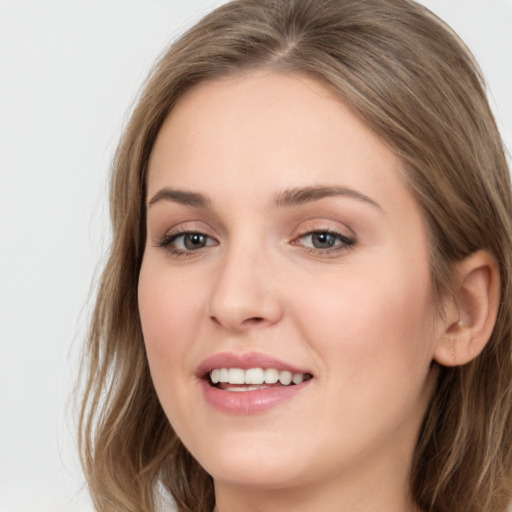 Joyful white young-adult female with long  brown hair and grey eyes