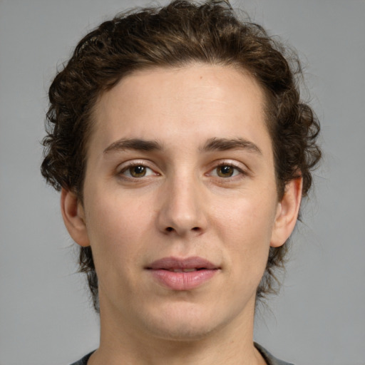 Joyful white young-adult male with medium  brown hair and green eyes