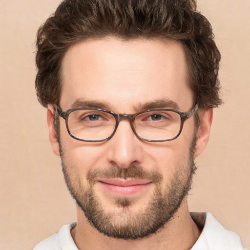 Joyful white adult male with short  brown hair and brown eyes