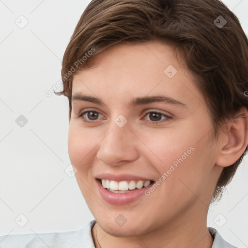 Joyful white young-adult female with short  brown hair and brown eyes