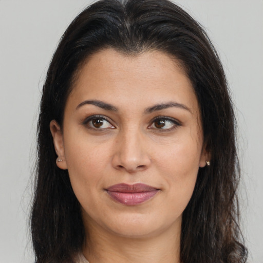 Joyful latino young-adult female with long  brown hair and brown eyes