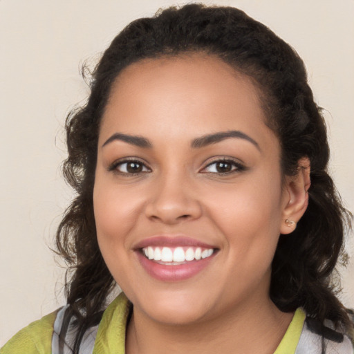 Joyful latino young-adult female with medium  brown hair and brown eyes