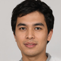 Joyful asian young-adult male with short  black hair and brown eyes