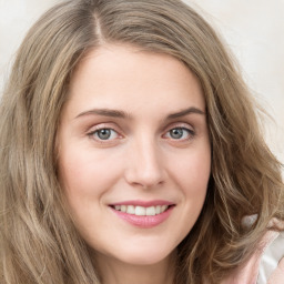 Joyful white young-adult female with long  brown hair and green eyes