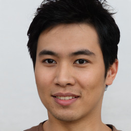 Joyful asian young-adult male with short  black hair and brown eyes