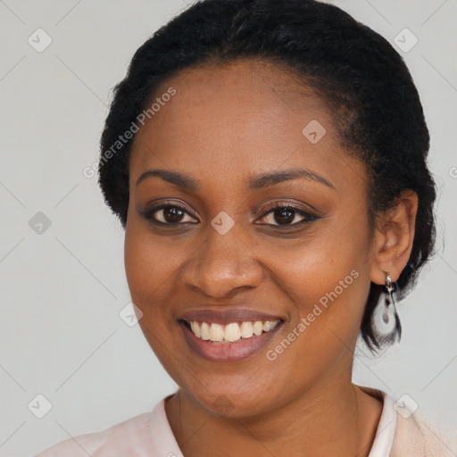 Joyful black young-adult female with medium  black hair and brown eyes