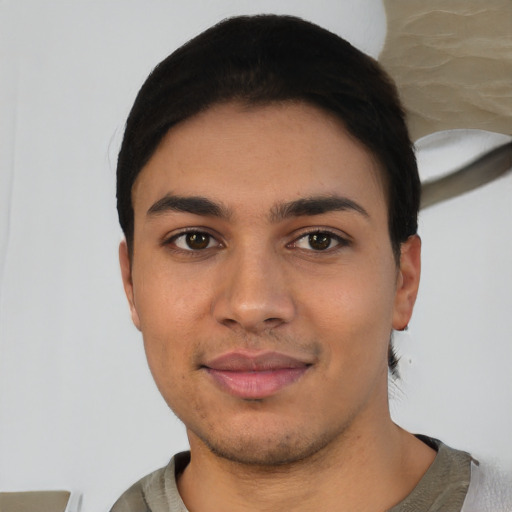 Joyful white young-adult male with short  black hair and brown eyes