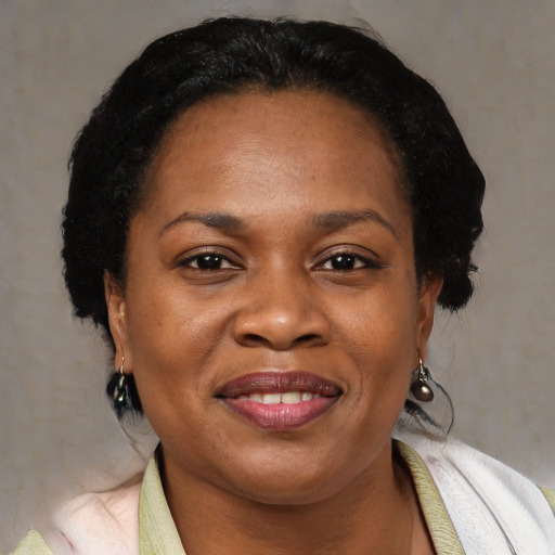 Joyful black adult female with short  black hair and brown eyes