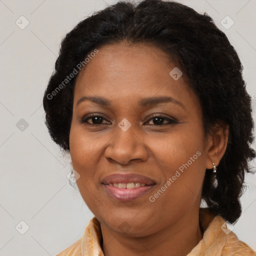 Joyful black adult female with medium  brown hair and brown eyes